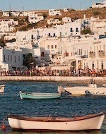 Coastline water boats against the cityscape of Mykonos island Cyclades Agean Sea Greece
