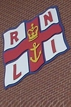 RNLI Logo on brick wall 140